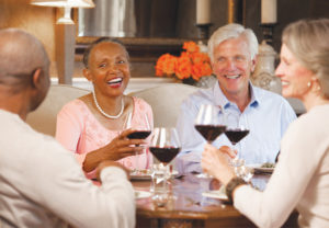 Older people saying cheers with wine